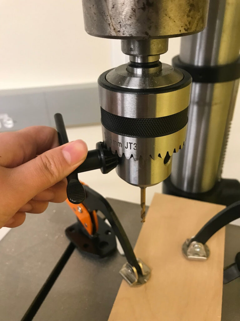 Using the chuck key to tighten a drill bit into the chuck, Northeastern Makerspaces