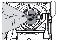 Removing the bobbin casing from the bottom of a Bernina sewing machine by pulling the lever, Northeastern Makerspaces