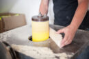 Person sanding wood on a spindle sander