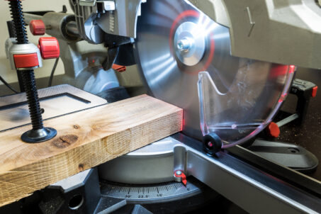 Cutting a block of wood on a chop saw