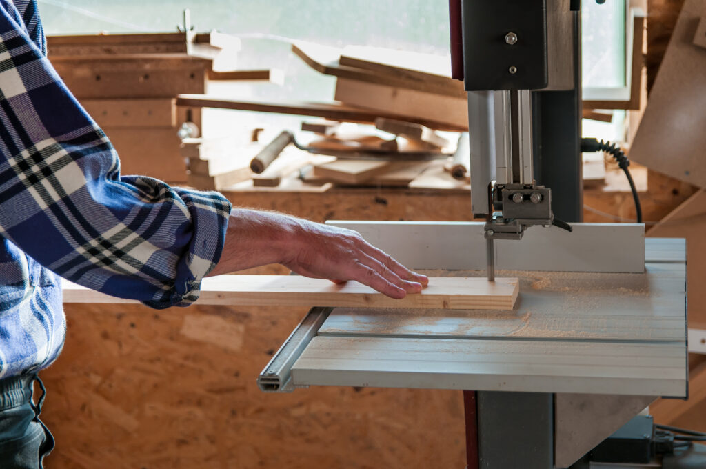 Cutting a piece of wood on a band saw