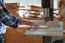 Cutting a piece of wood on a band saw