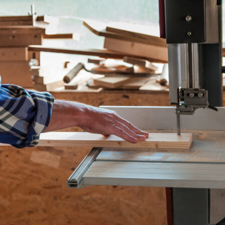 Cutting a piece of wood on a band saw