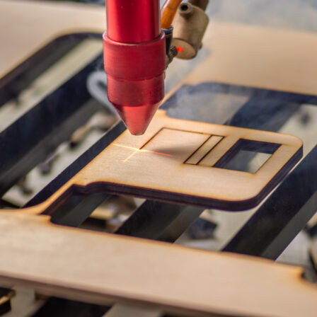 Laser cutting cutting out a piece of plywood