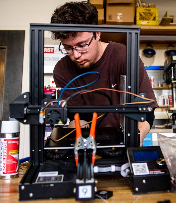 Student engages with 3-D printer 
