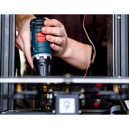 Architecture student replaces a motherboard on a 3D printer in the CAMD Makerspace.