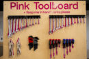 A pink toolboard with hand tools