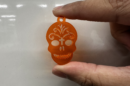 Skull keychain held by 2 fingers