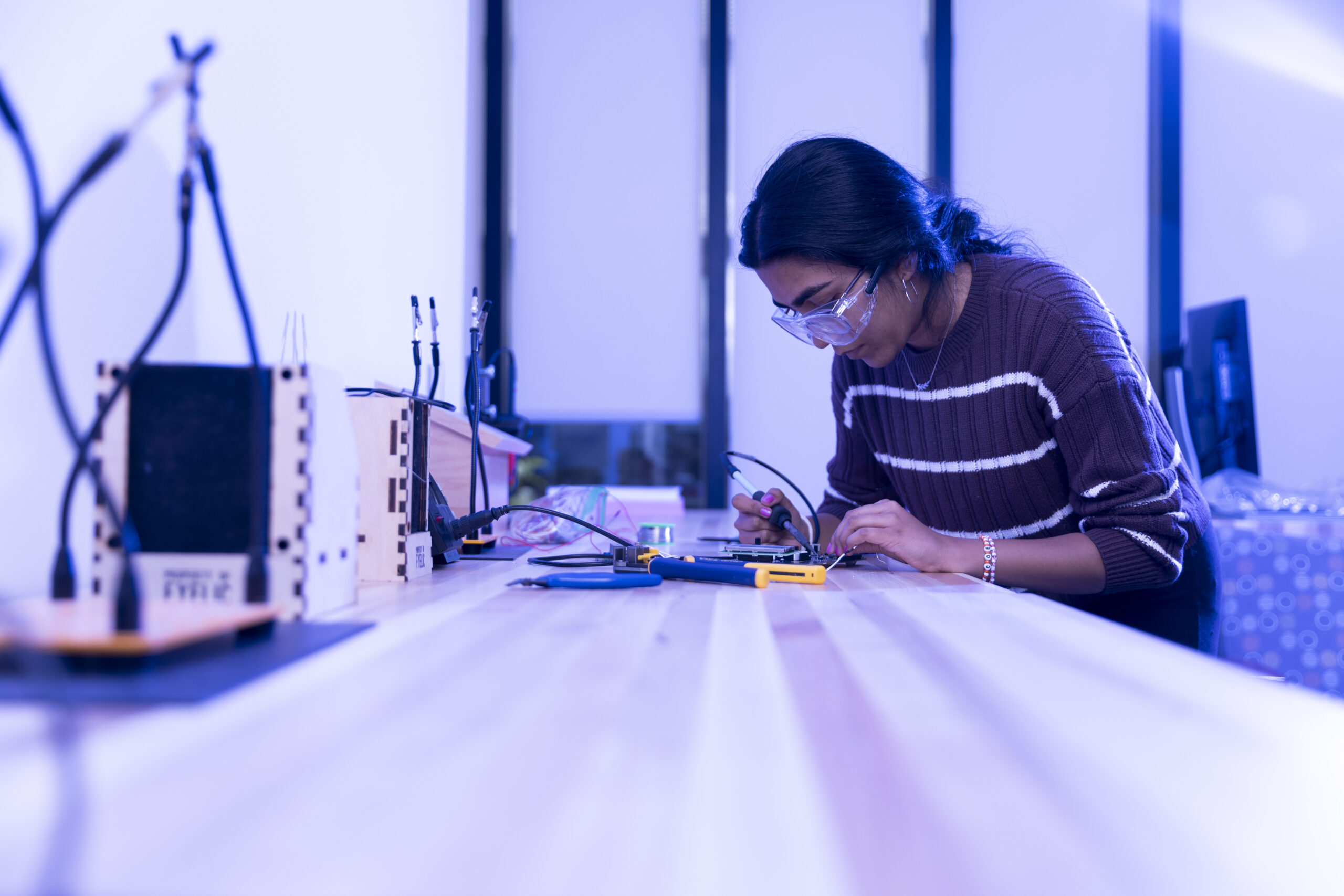 A student solders a project.