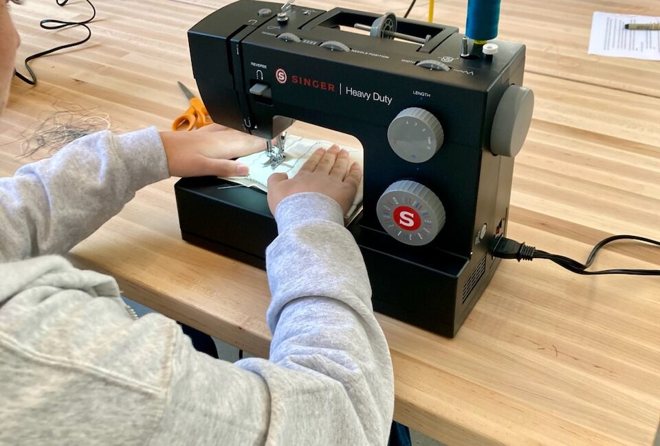 Person using sewing machine