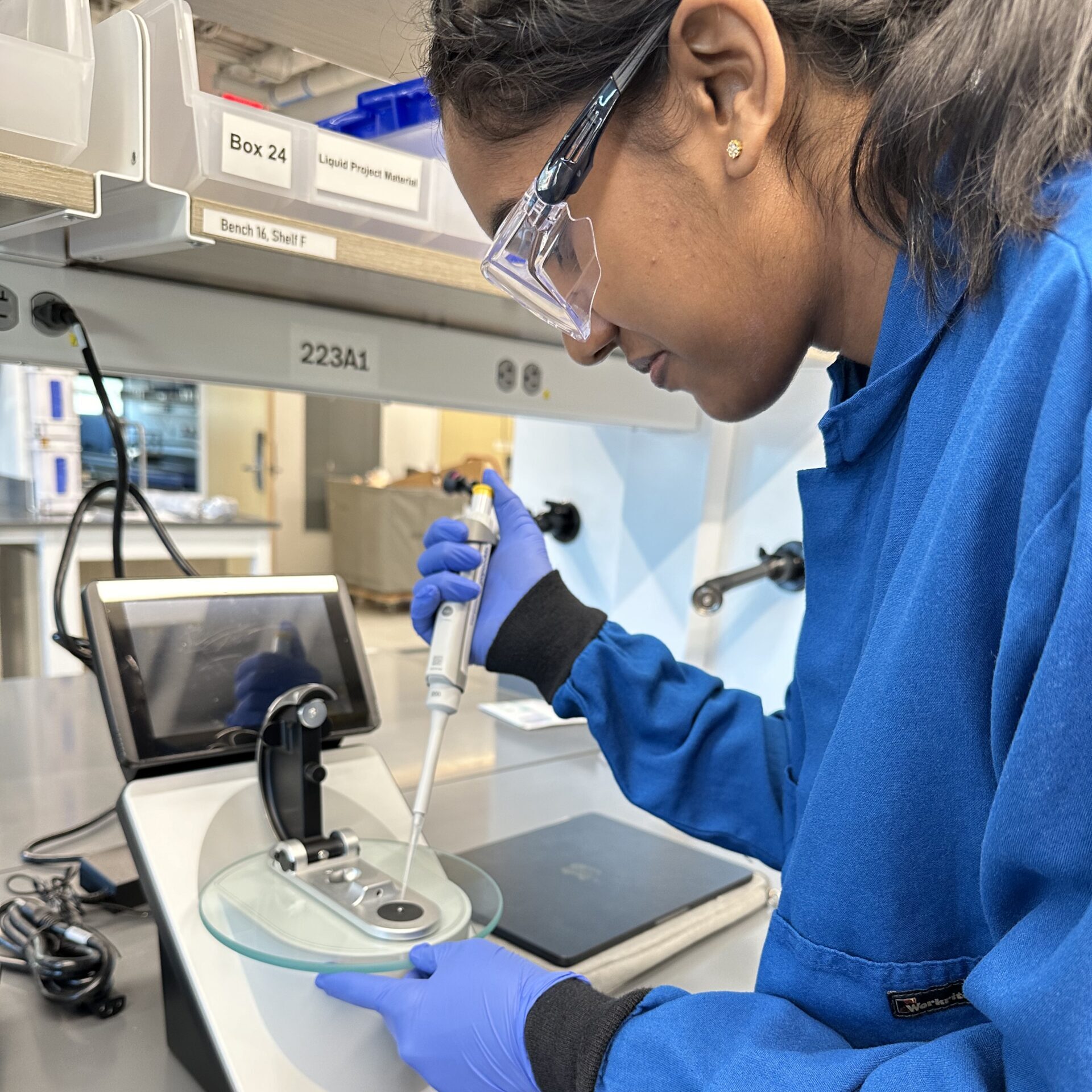 Student using a piece of biological testing equipment.