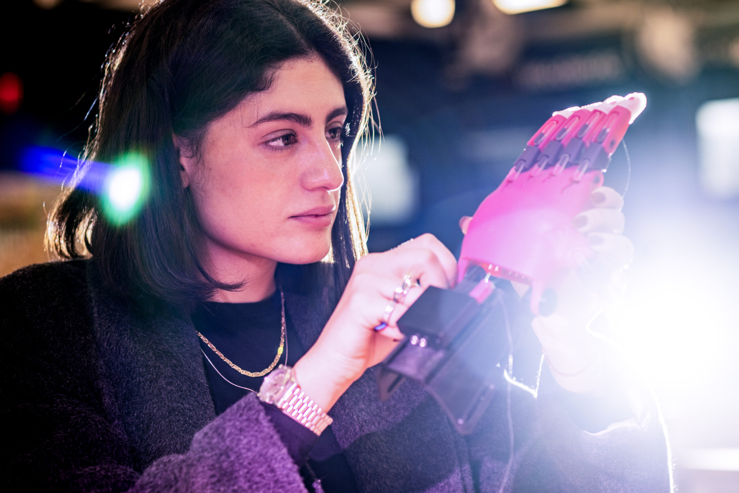 A student works on a 3D printed hand.