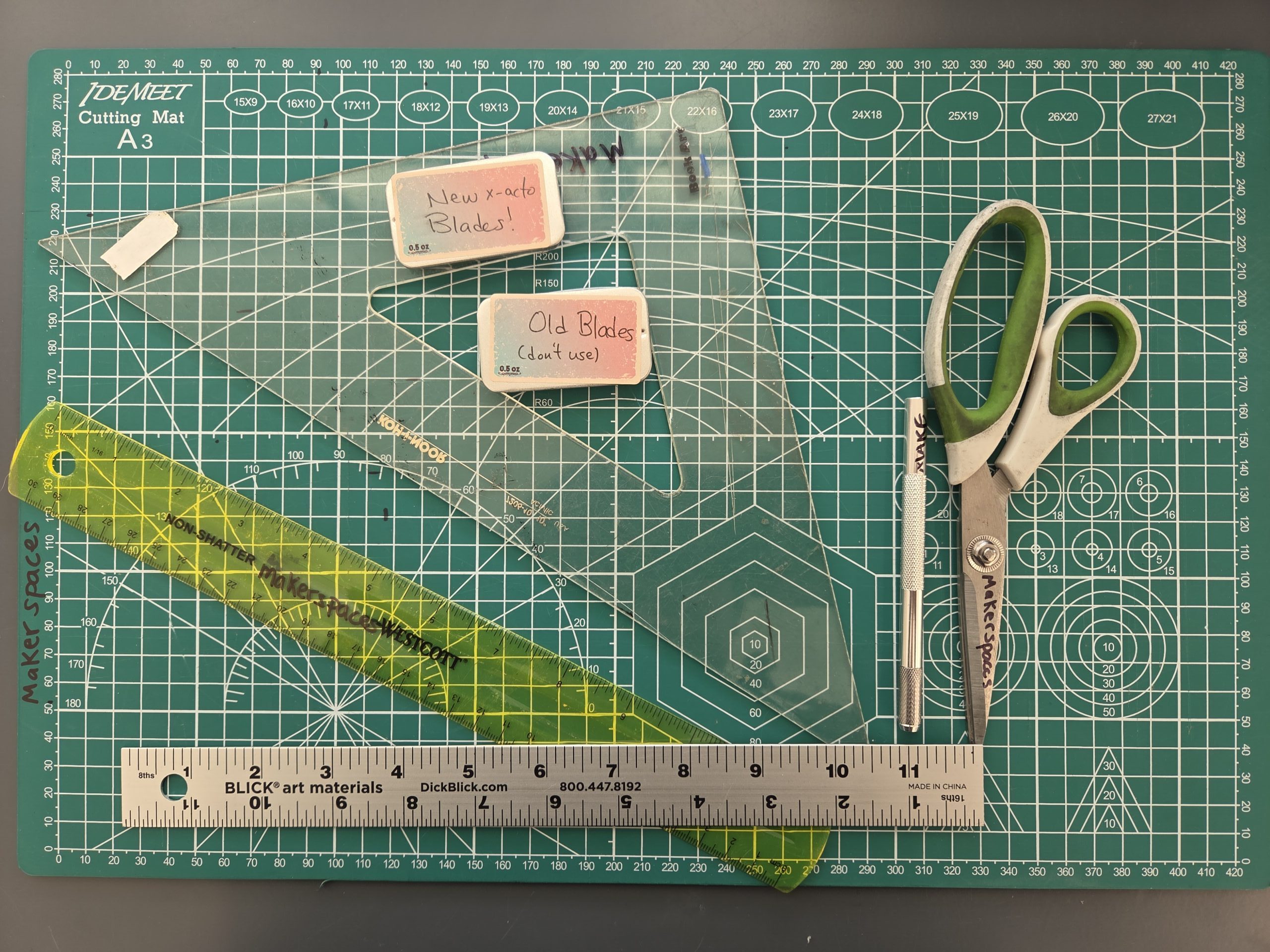 20250407_145654 A cutting mat with scissors and various measuring tools.