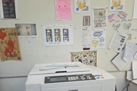 A specialized printer surrounded by its prints.
