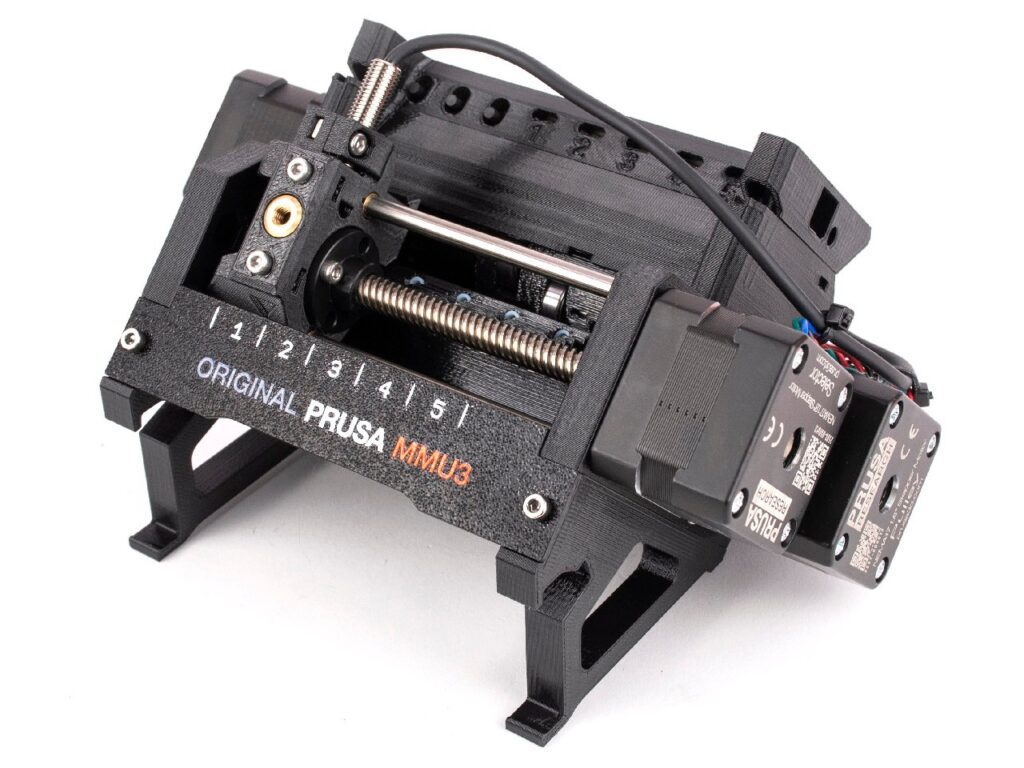 Black plastic device with gears, buttons and the words "original prusa MMU3" on the front
