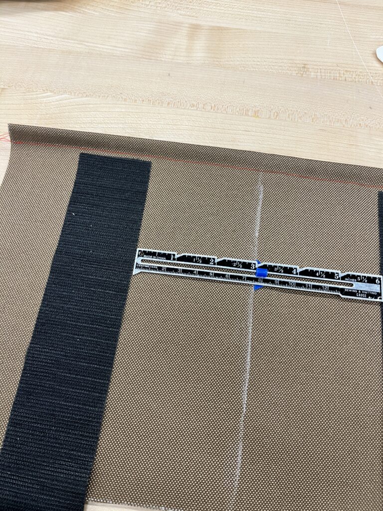 velcro strip 3 inches away from center of fabric, shown with a ruler. 