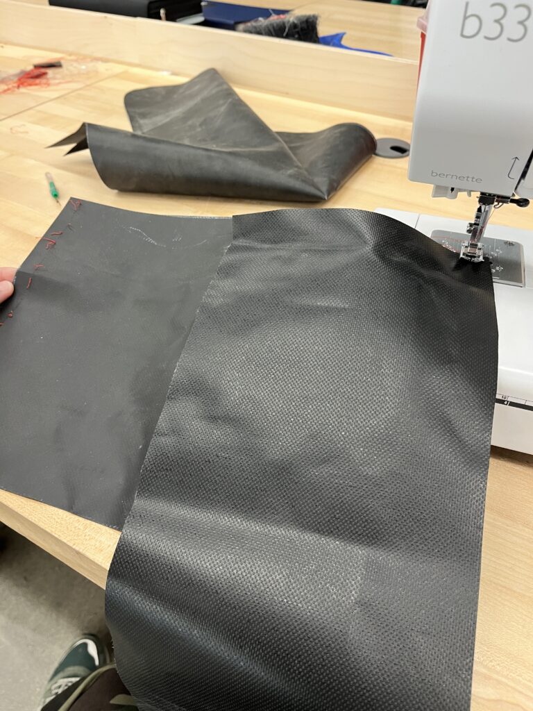 black tarp being sewn