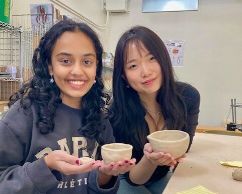 ceramics02 Students hold their ceramics pieces.
