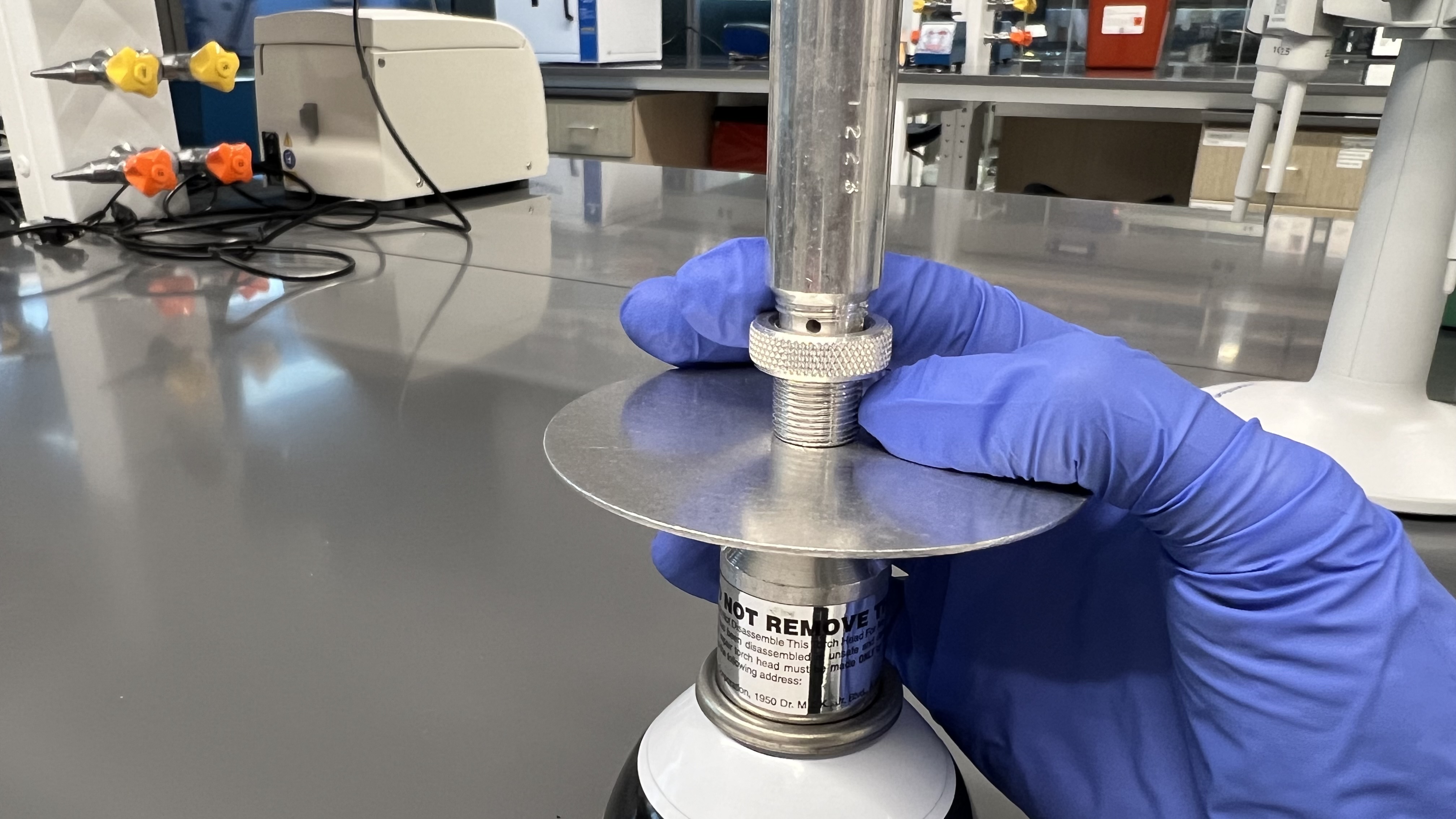 Butane burner with a yellow flame indicating incomplete combustion